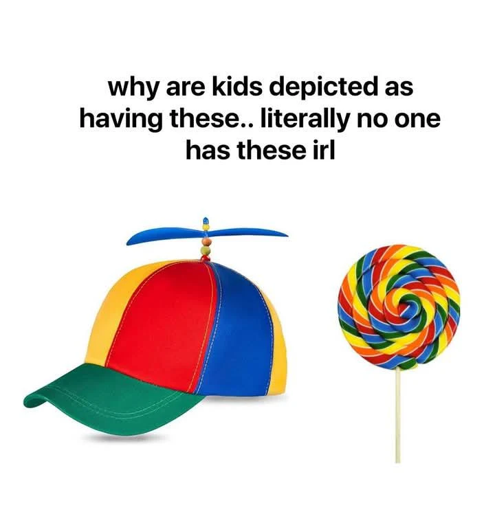 The meme features a colorful propeller beanie hat and a large swirl lollipop with text above them. The text asks, 'why are kids depicted as having these.. literally no one has these irl'. The joke highlights the absurdity of cartoon or media tropes where children are always shown with exaggerated, stereotypical items like a propeller hat and giant candy, which are unrealistic for real life.